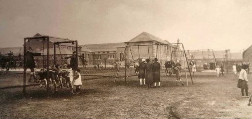 Newtongrange Welfare Park Children Centre/Playpark with children/adults in foreground and Primary school in background.